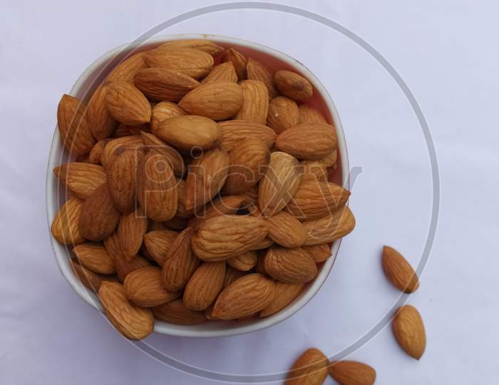 One bowl of almonds kept on white background