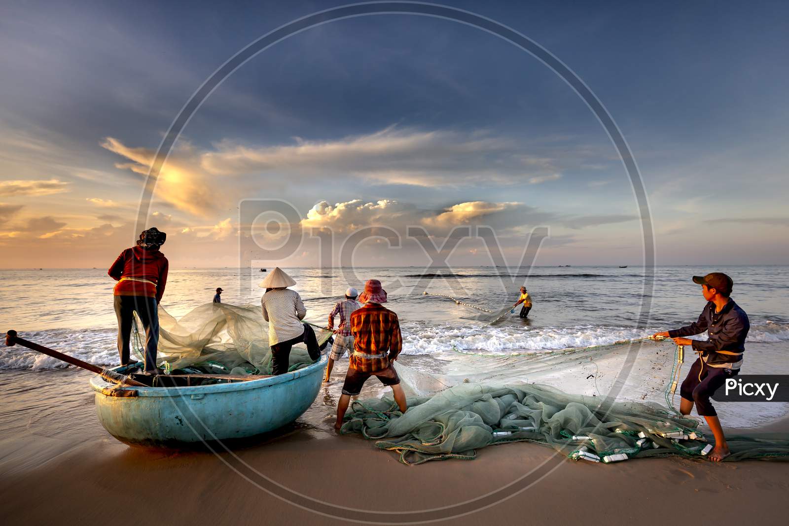 Image of Scenery of local fishermen pulling fish nets-NF616723-Picxy