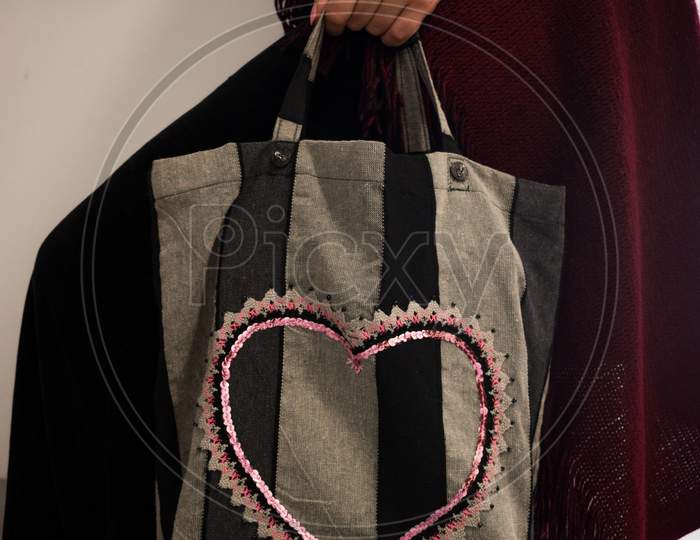 Woman'S Hand Holding A Fabric Tote Bag