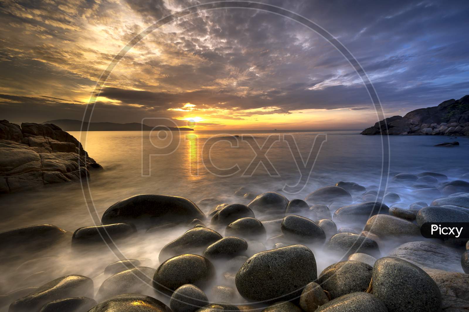 Long exposure of sea and stones, beautiful sunrise in Quy Nhon city, Vietnam