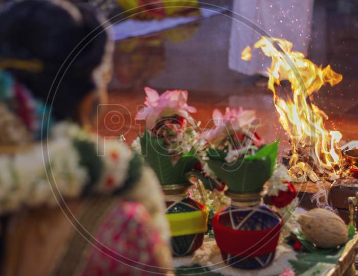 Selective focus shot of a female in wedding Yajna/Yagya Hinduism ritual