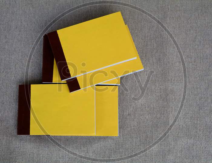 Yellow Color Bill Books Or Receipt Books On A Cream Color Furnishing Cloth