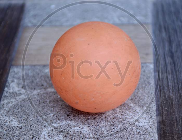 The Orange Color Old Ball Isolated On Grey Background.