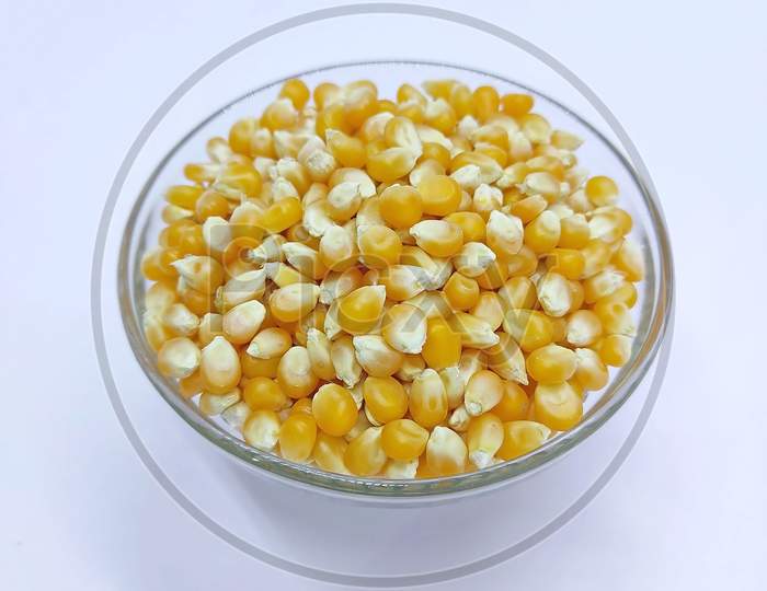 Corn Kernels, Falling Corns Seeds, Yellow Dry Corn Grains In Bowl On White Background