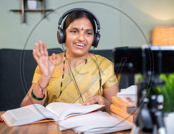 Indian Woman Greeting Students In Front Of Mobile During Virtual Online Class At Home - Concept Of New Normal Education, E-Teaching, Technology During Covid-19 Pandemic.