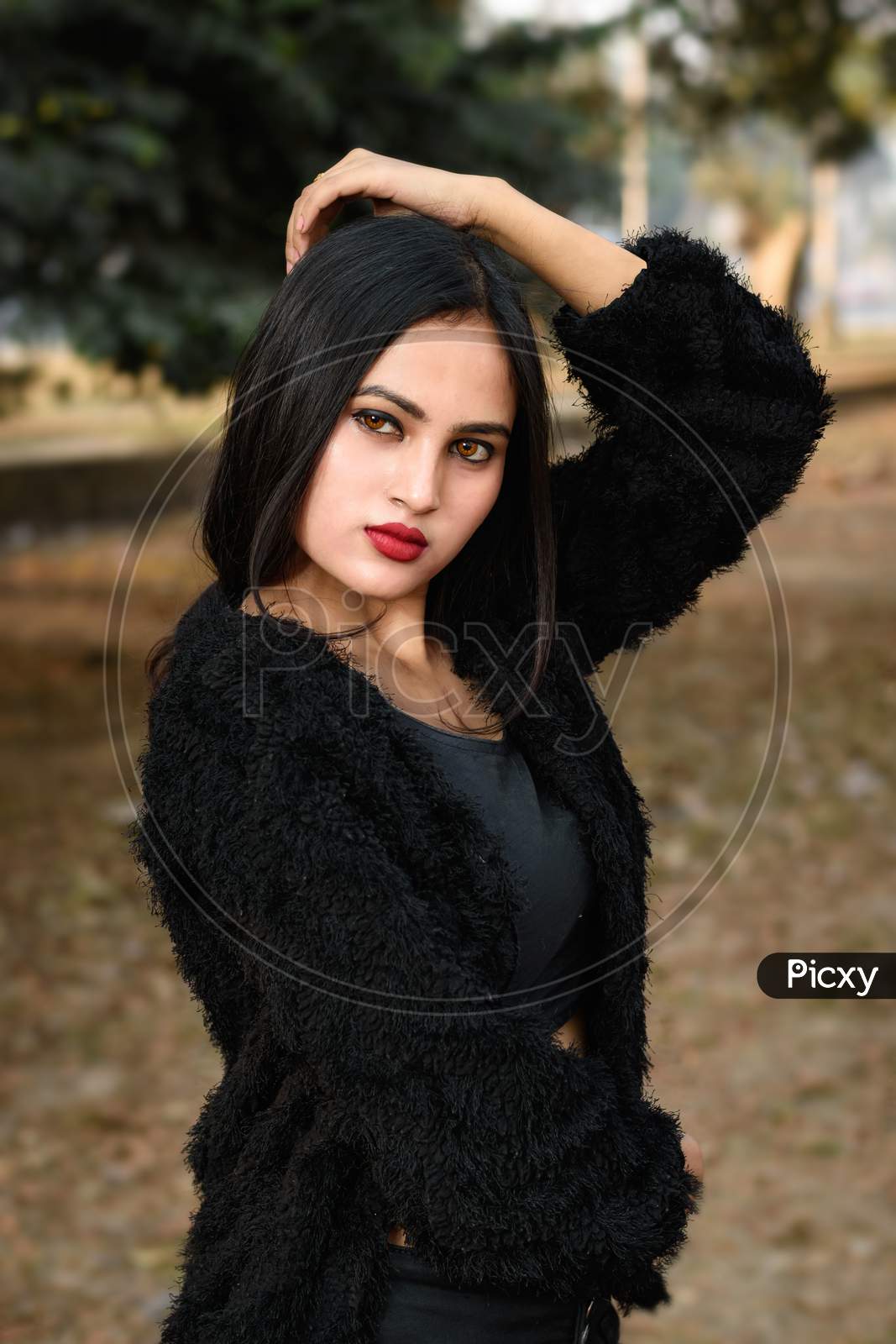 Portrait Of Very Beautiful Young Attractive Brunette Indian Woman Wearing Black Outfit Posing Fashionable In A Blurred Background. Lifestyle And Fashion.