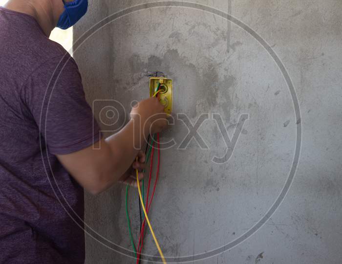 Electrician Working On A Construction Site. Electrical Wiring In A Construction.
