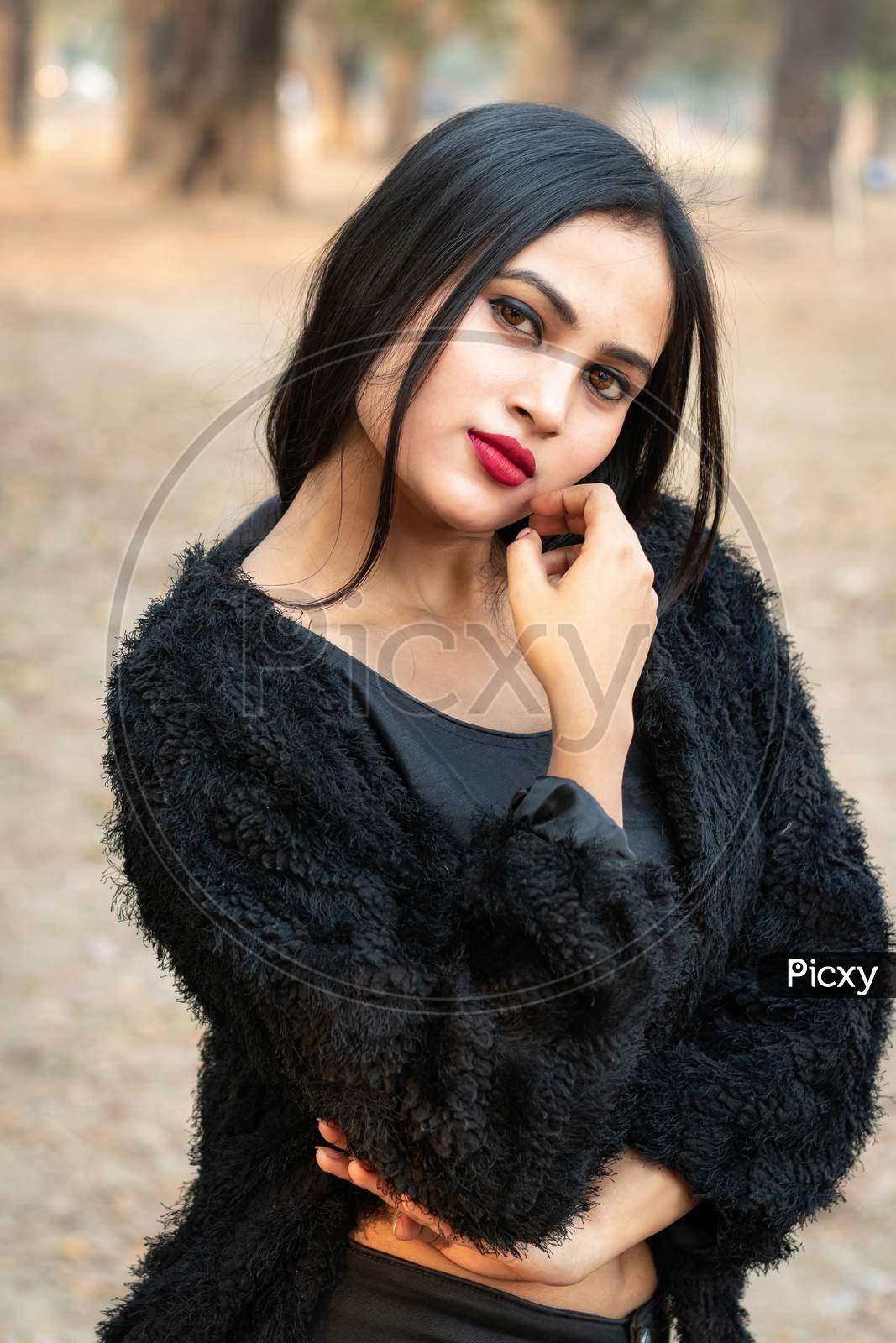 Portrait Of Very Beautiful Young Attractive Brunette Indian Woman Wearing Black Outfit Posing Fashionable In A Blurred Background. Lifestyle And Fashion.