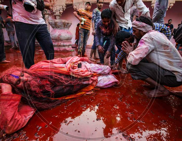 Barsana, Uttar Pradesh, India February 12 2021: Indian Ordinary Man Taking Ashirvaad Or Blessing From Sant Sadhu Baba. People Celebrating Holi In Barsana.