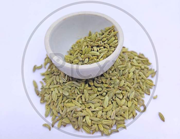 Dried Fennel Seeds In Bowl On White Background