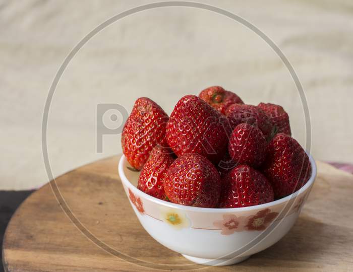 Fresh Organic Red Strawberry In A Bowl On Wooden Table.
