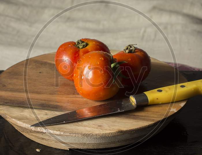 Fresh Organic Tomatoes On Wooden Table.