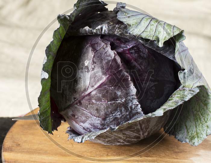 Fresh Organic Red Cabbage On Black Table.