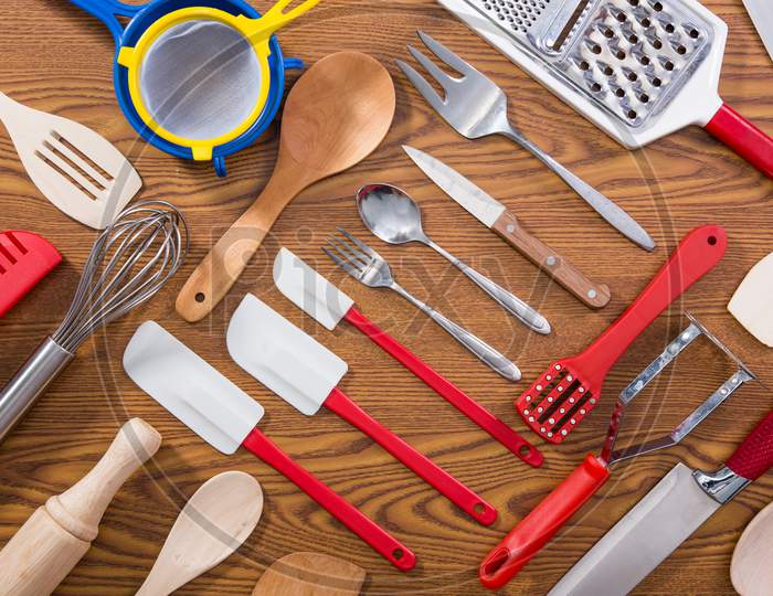 Row of assorted wooden kitchen utensils Stock Photo by ©oocoskun