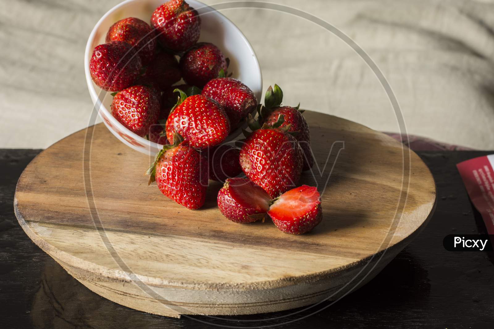 Fresh Organic Red Strawberry Cut Into Two Pieces And Some In A Bowl On Wooden Table.