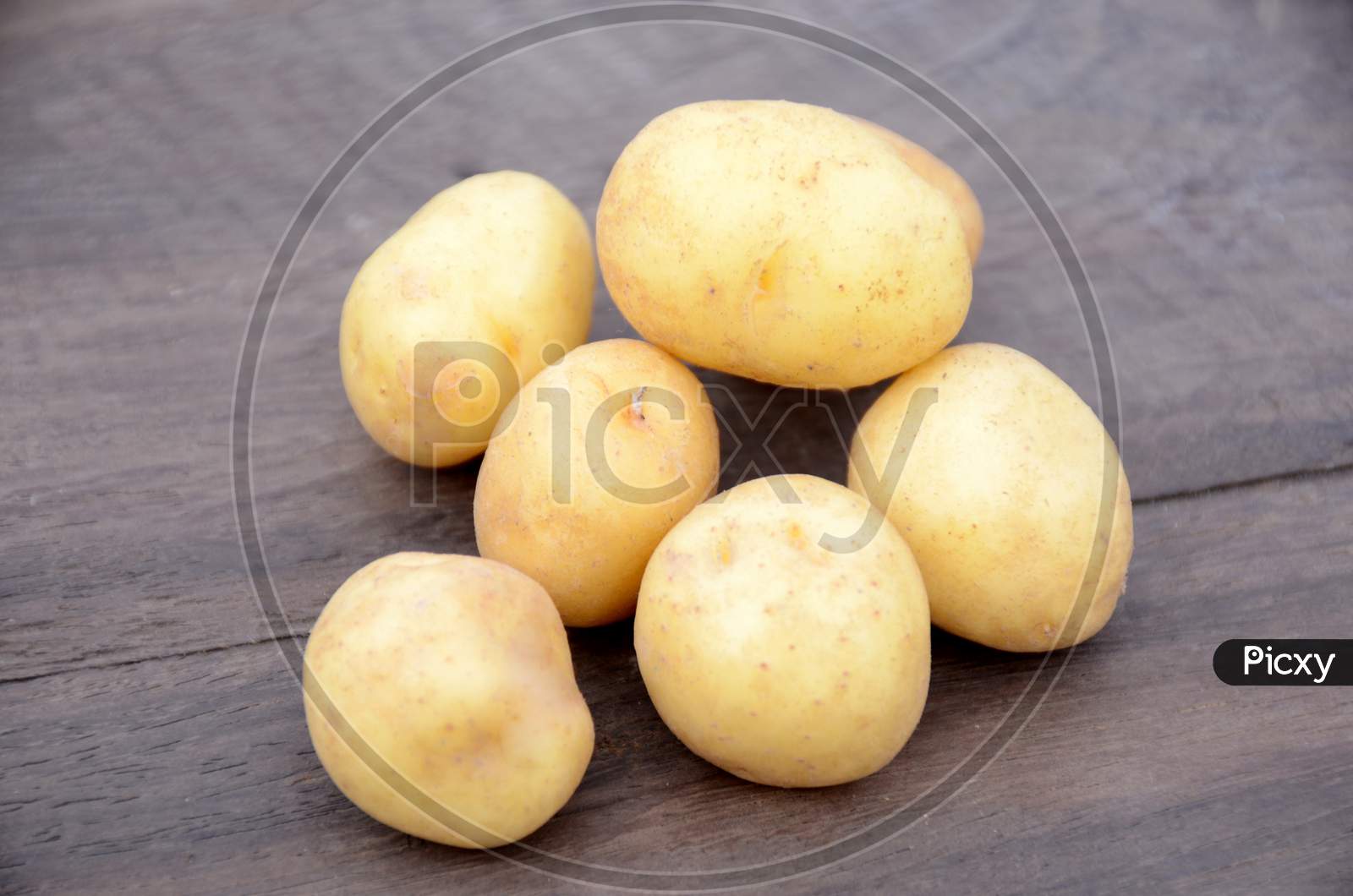 Bunch The Fresh Ripe Potato On The Wooden Background.
