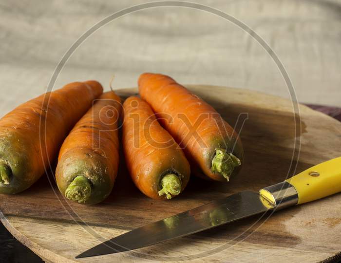 Fresh Organic Carrots On Wooden Table.
