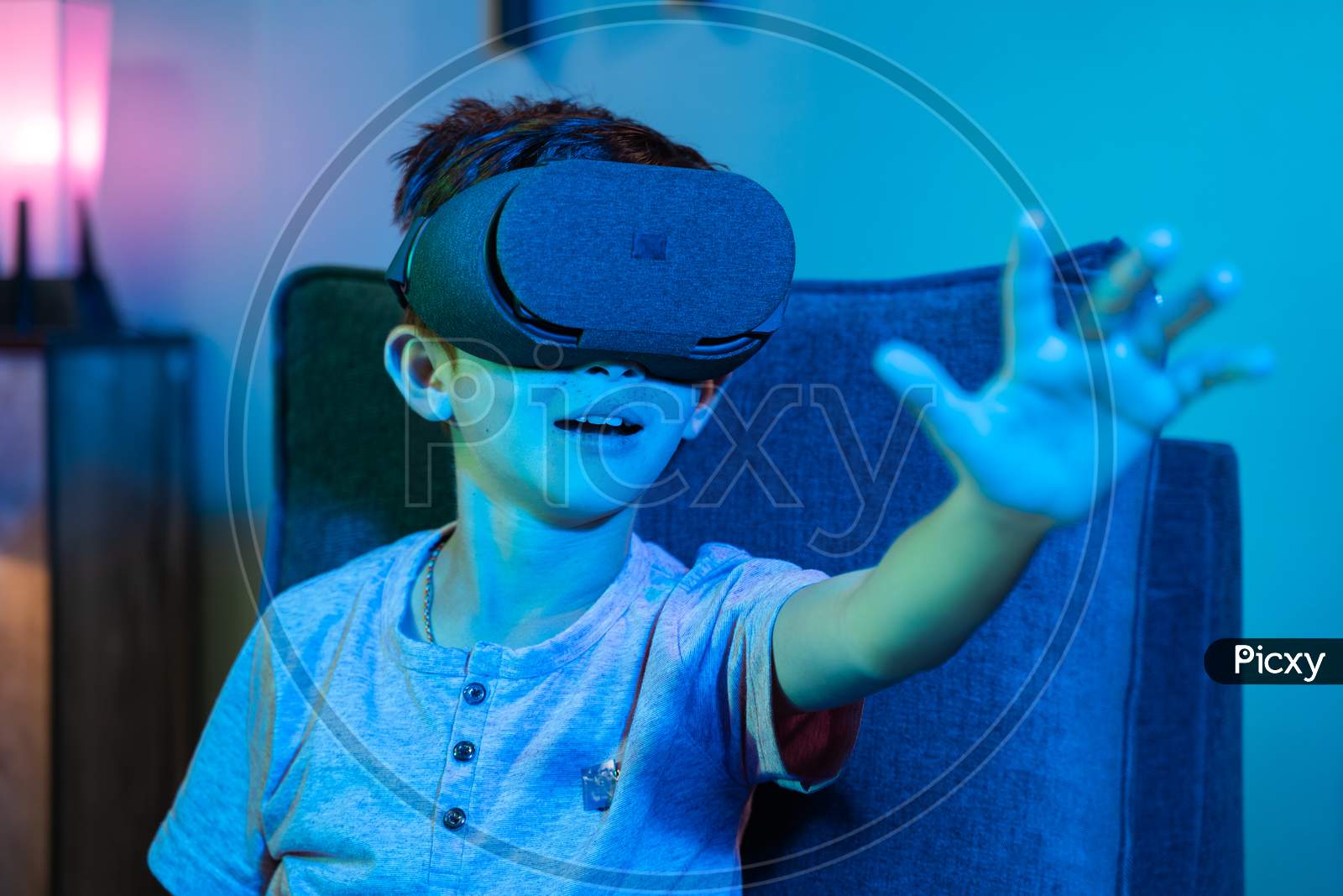 Young Kid With Vr Or Virtual Reality Headset Feeling Or Enjoying The 360 Degree Virtual Environment - Concept Of Showing Futuristic Of Modern Vr Technology In Modern Lifestyle.