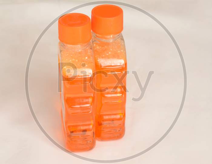 The Orange Color Sanitizer Plastic Bottle Isolated On White Background.