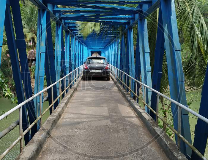 Driving a car on a narrow bridge