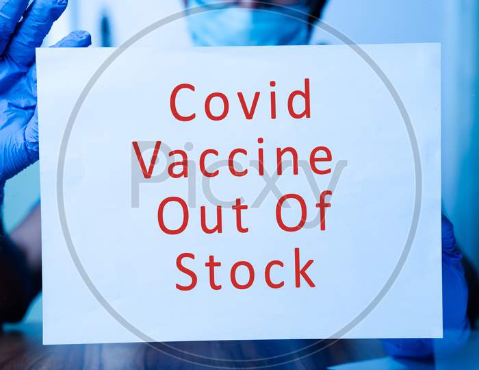 Selective Focus On Notice, Doctor Or Nurse Pasting Covid-19 Vaccine Not Available Notice On Door Front In The Hospital.