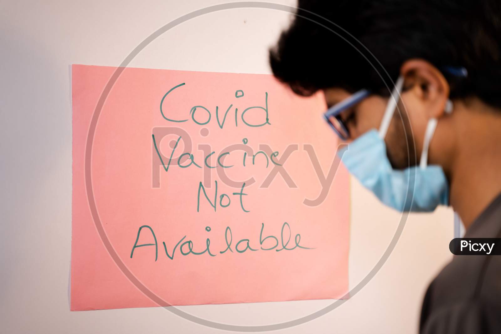 Selective Focus On Notice Board,Young Man Got Worried After Looking Covid-19 Vaccine Not Available Notice Board On Hospital Door - Concept Of Coronavirus Vaccine