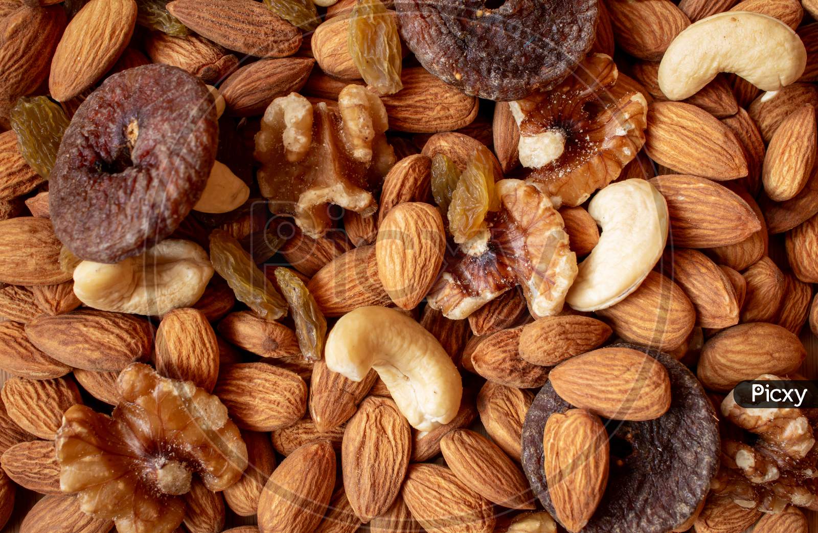 Mix Of Dry Fruits Containing Almonds, Walnuts, Raisins And Dried Figs. Healthy Food Concept