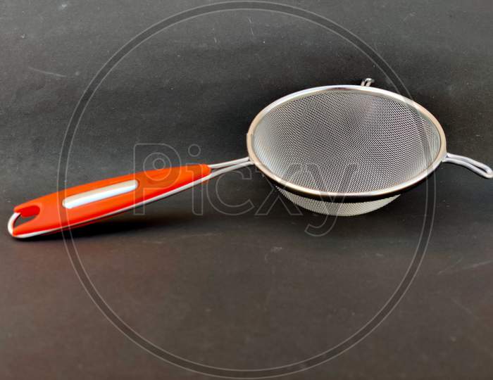 Side View Of Stainless Steel Soup & Juice Strainer Or Liquid Filter Isolated On Black Background