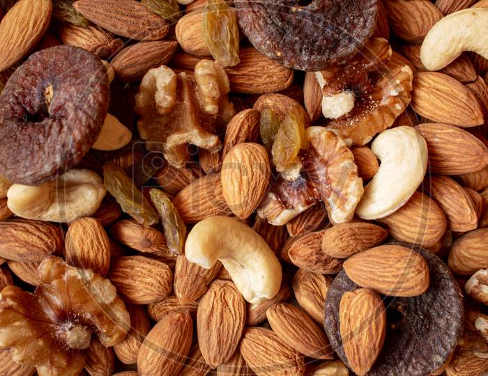 Mix Of Dry Fruits Containing Almonds, Walnuts, Raisins And Dried Figs. Healthy Food Concept