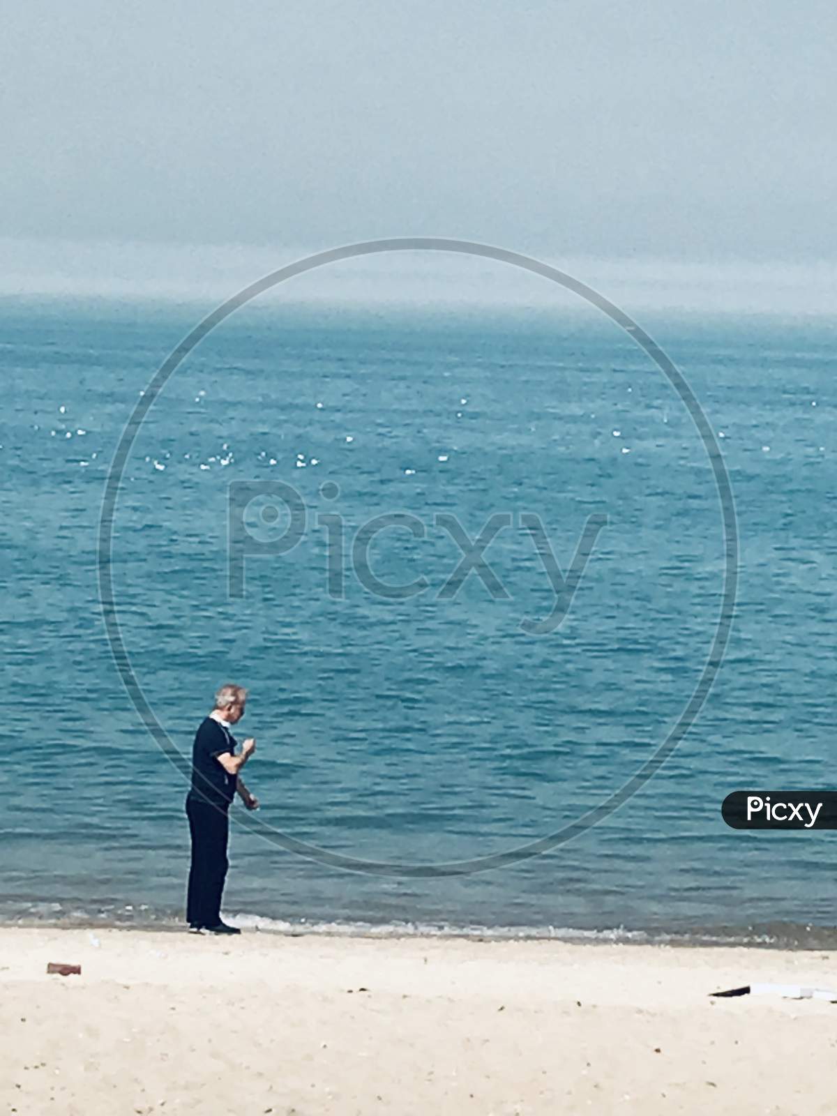 Image of A man fishing on the (Shraq) beach kuwait-SG158191-Picxy
