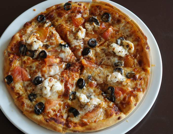 Thin crust Prawn pizza with black olives, tomatoes & mozzarella cheese
