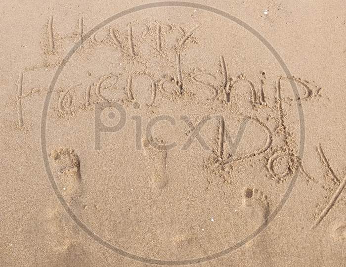 Happy Friendship Day wrote on Sand