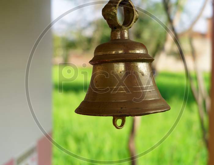 Bronze Temple Ring Bell For Powerful Sound. Handmade Brass Ring Bell In Temple With Blurred Background.