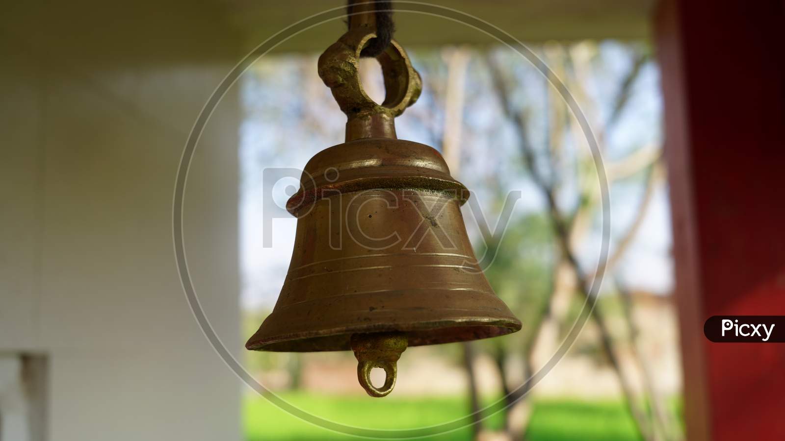 Selective Focus On Temple Ring With Blurred Background. Brass Temple Ghanta Or Bell For Sound Vibrations In Hindu Temple.