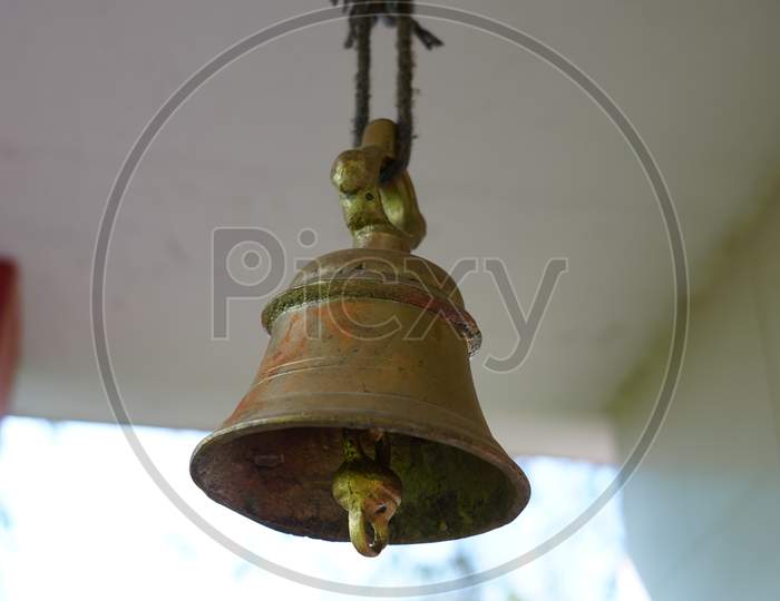 Hanging Brass Of Temple Ring Attached With Rooftop. Devotional Brass Ring Bell Closeup In A Temple.