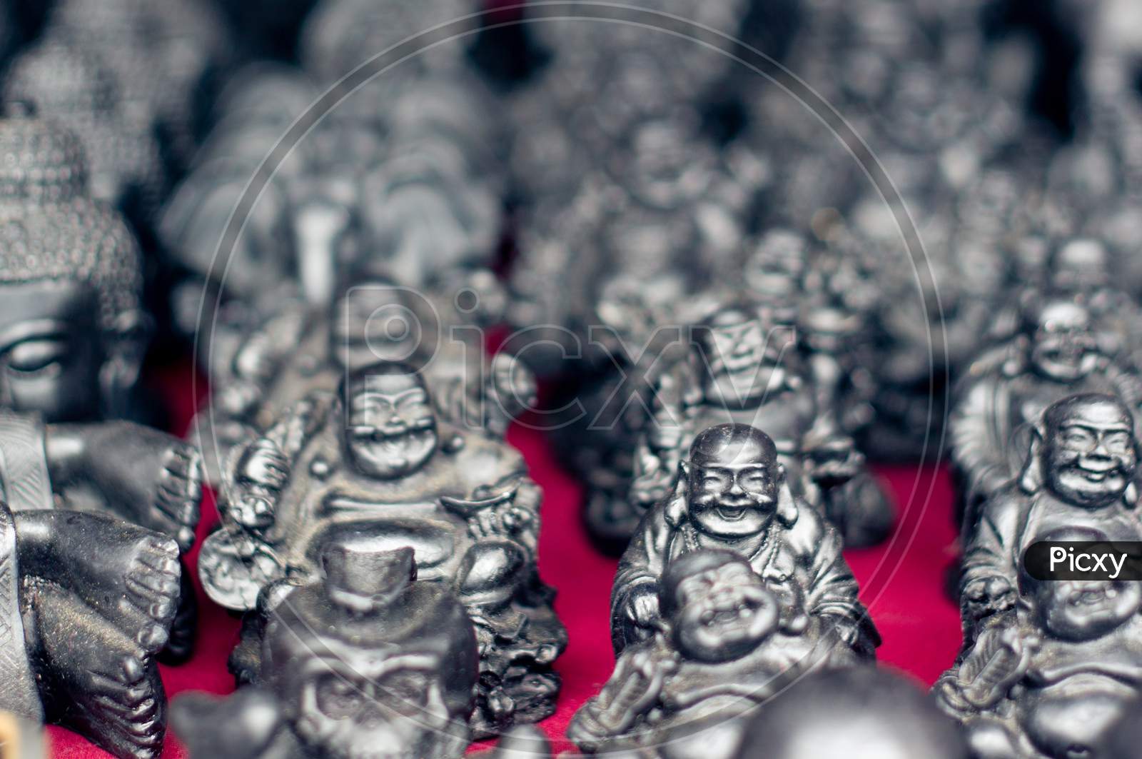 Silver Bhudda Statues Placed On A Red Mat In In An Open Shop Ready To Sell Near A Monastry In Bhutan, Mcleodganj, Dharamshala, Nepal And More Tourist Places In India