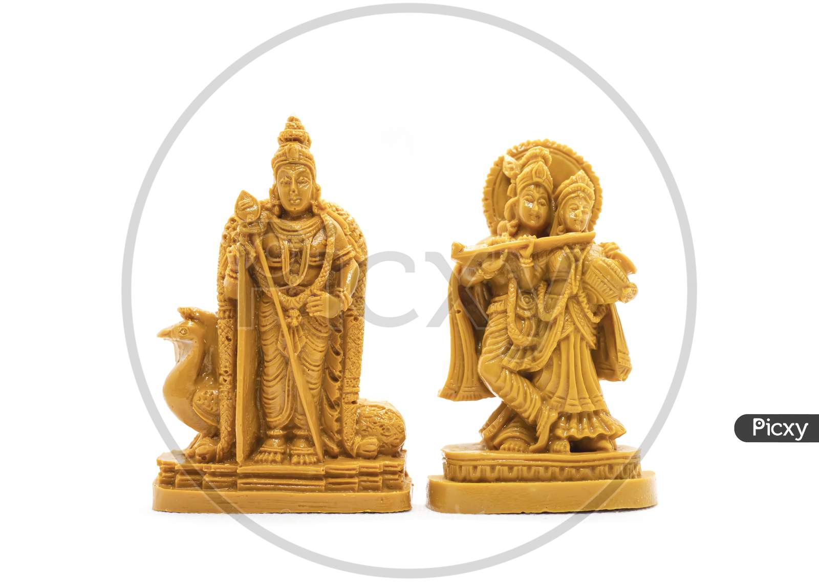 The Hand-Carved Wooden Idol Of Lord Murugan With Radha Krishna Is Isolated On A White Background