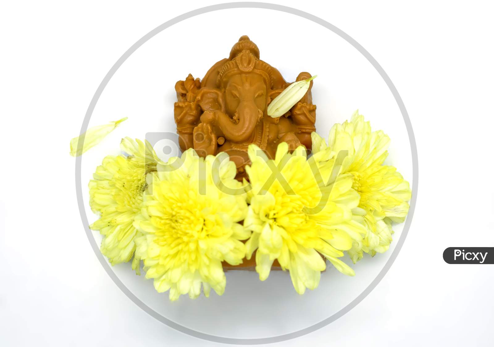 Ganesha Statue With Yellow Flowers Of Hindu God On White Background At The Top View