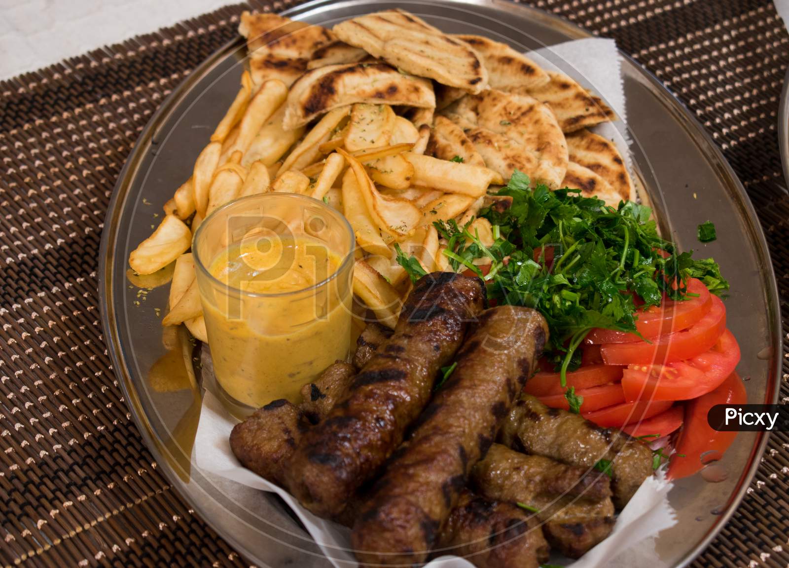 Traditional Lamp Kebab With Fresh Salad, Potatoes And Sauce In Plate