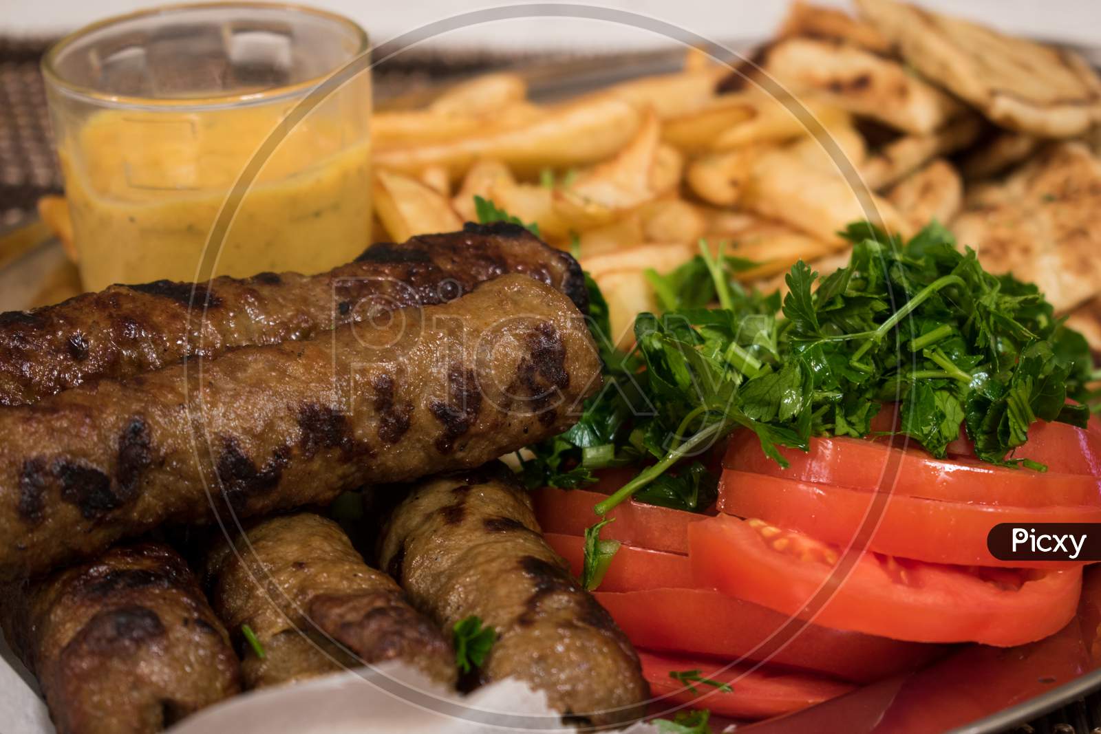 Traditional Lamp Kebab With Fresh Salad, Potatoes And Sauce In Plate