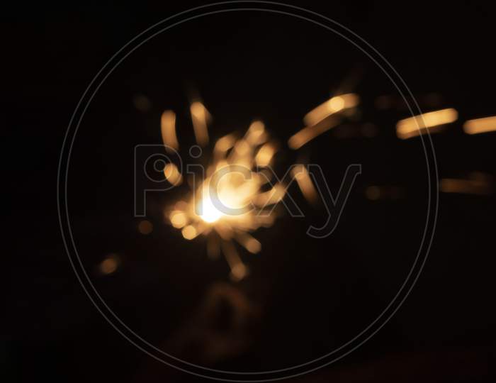 Faint Sparks From The Fire In Front Of The Black Backgrounds