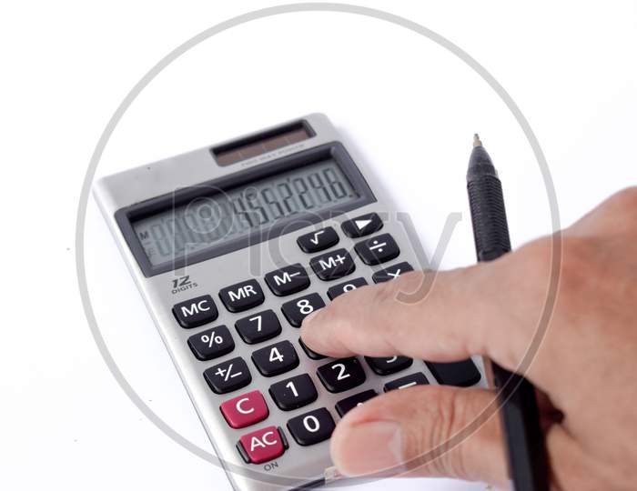 Close up photo of finger and calculator to calculate economy and finance