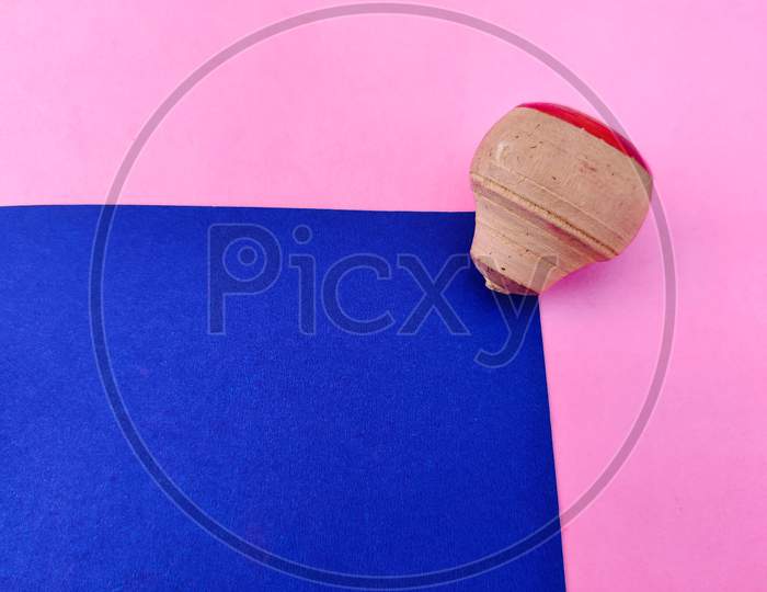 Copy Space Of Small Wooden Spinning Top Isolated On Blue And Pink Background