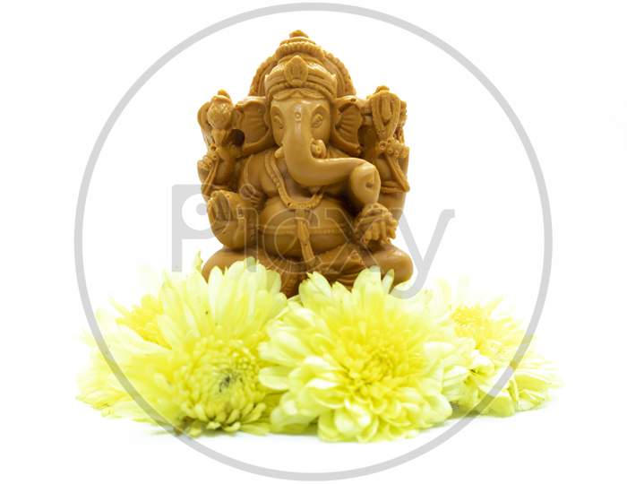 Ganesha Statue Of Hindu God With Flowers On White Background.