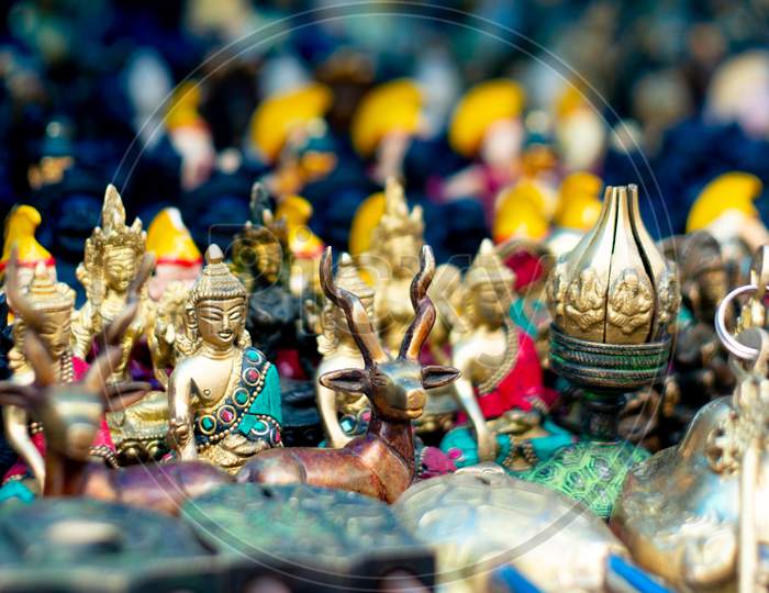 Miniature Buddha Statues On A Roadside Store As A Souvenir For Tourists Looking For Handmade Items In Rajasthan, Jaipur, Dharamshala And More