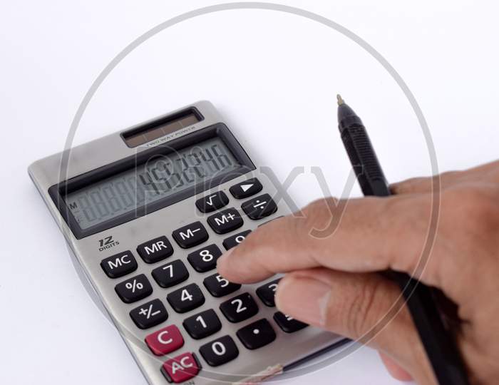 Close up photo of finger and calculator to calculate economy and finance