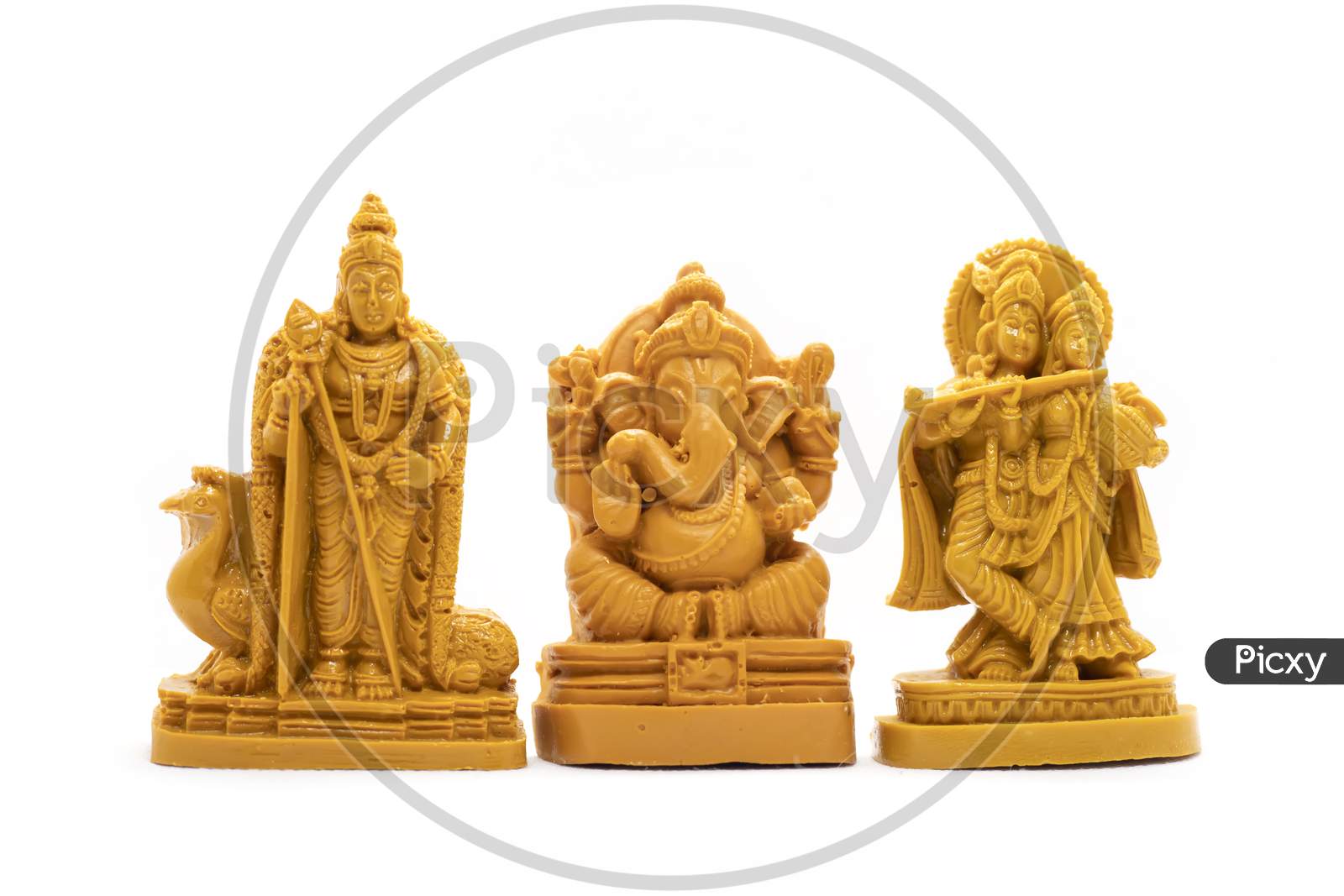 The Hand-Carved Wooden Idol Of Lord Murugan With Radha Krishna And Ganesha Is Isolated On A White Background