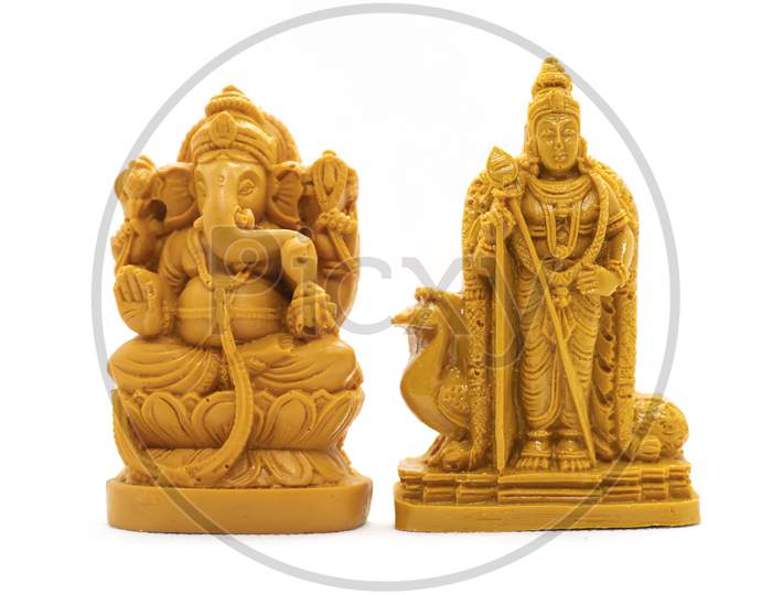The Hand-Carved Wooden Idol Of Lord Murugan With Ganesha Is Isolated On A White Background