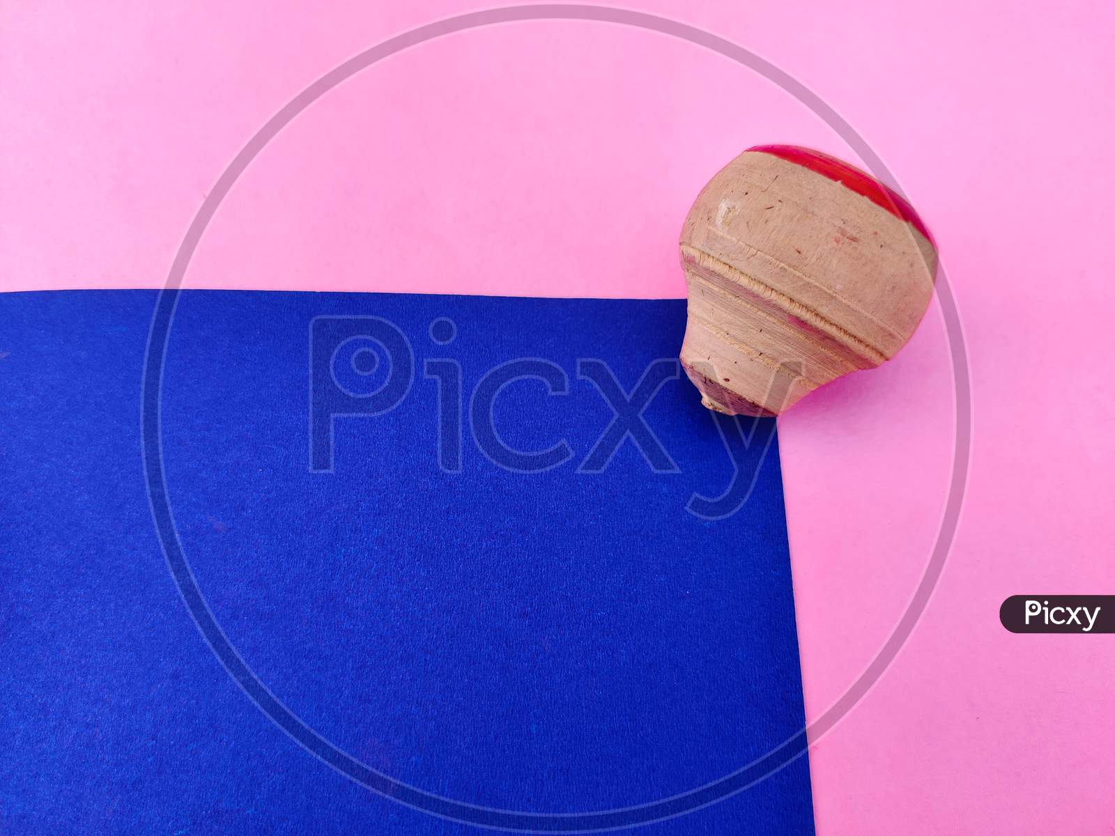 Copy Space Of Small Wooden Spinning Top Isolated On Blue And Pink Background