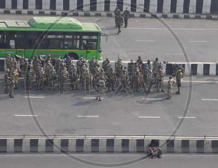 Security personnel stand near the barricades as farmers continue their protest against the central government's recent agricultural reforms at Delhi-Uttar Pradesh border in Ghaziabad on February 2, 2021.